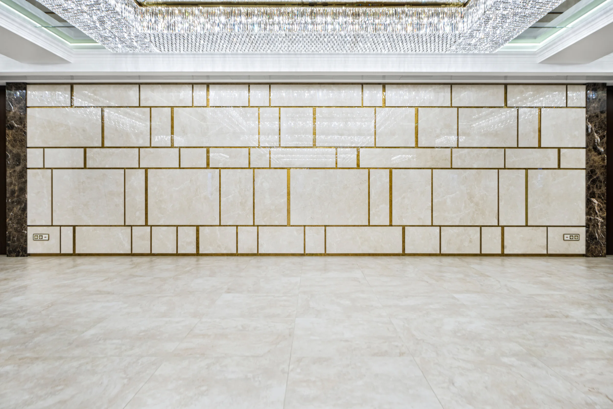 Grid of stone wall panels above a polished floor