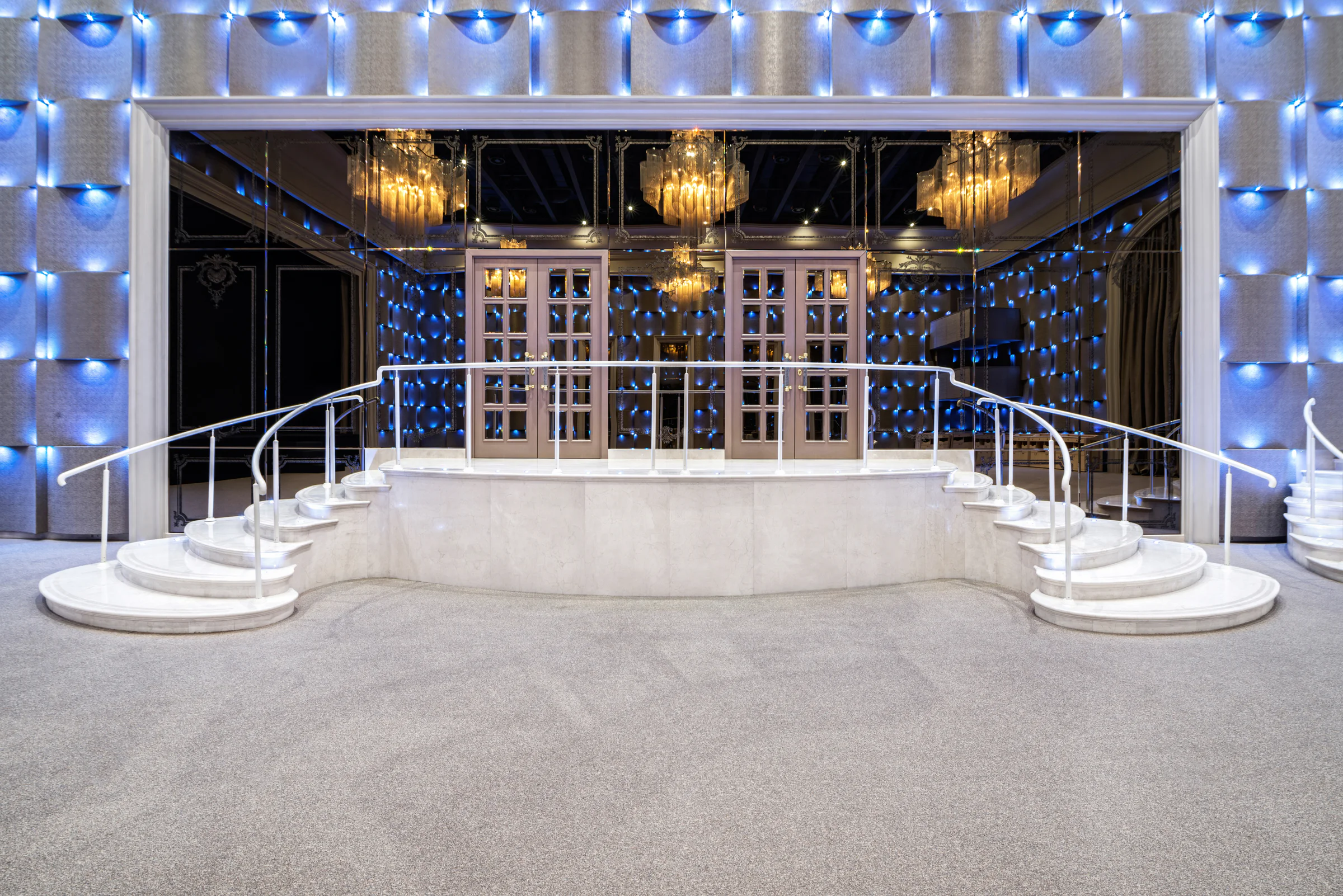 Stone platform and steps beneath the lit interior