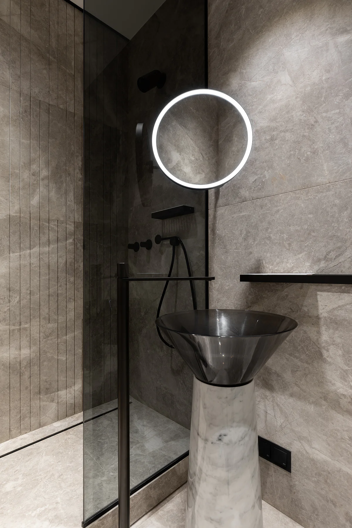 Freestanding grey stone basin and wall detailing
