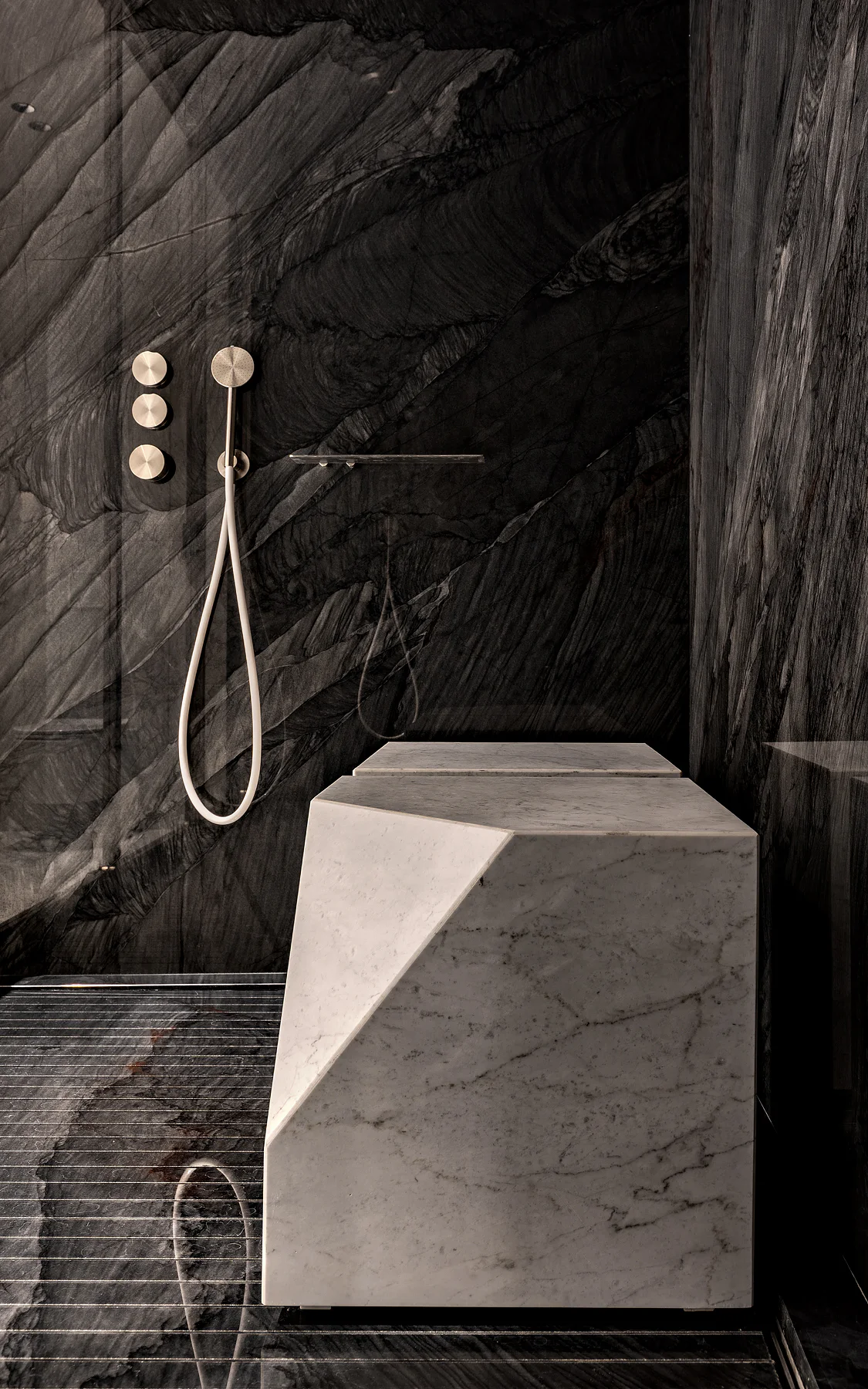 Angular stone bench and dark stone wall detail